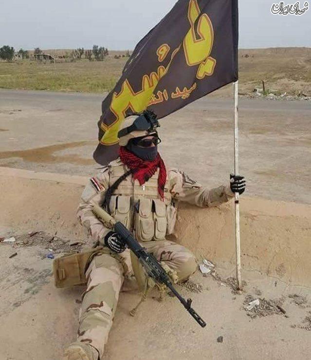 پرچم رزمنده عراقی در نبرد با داعشیان+عکس