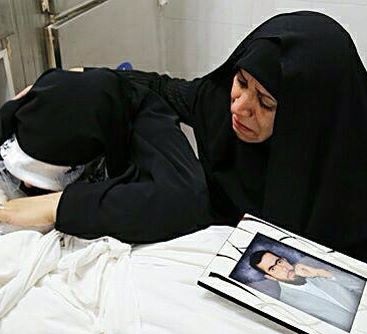 آخرین وداع همسر شهید مدافع حرم +عکس