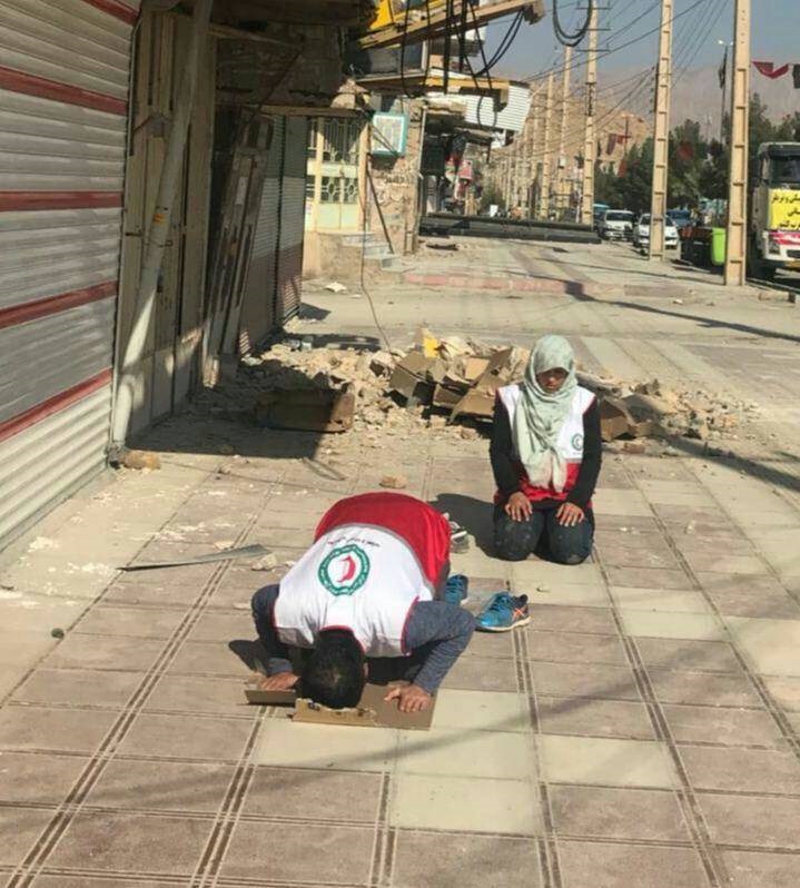 نماز اول وقت دو امدادگر در شهر زلزله زده + عکس